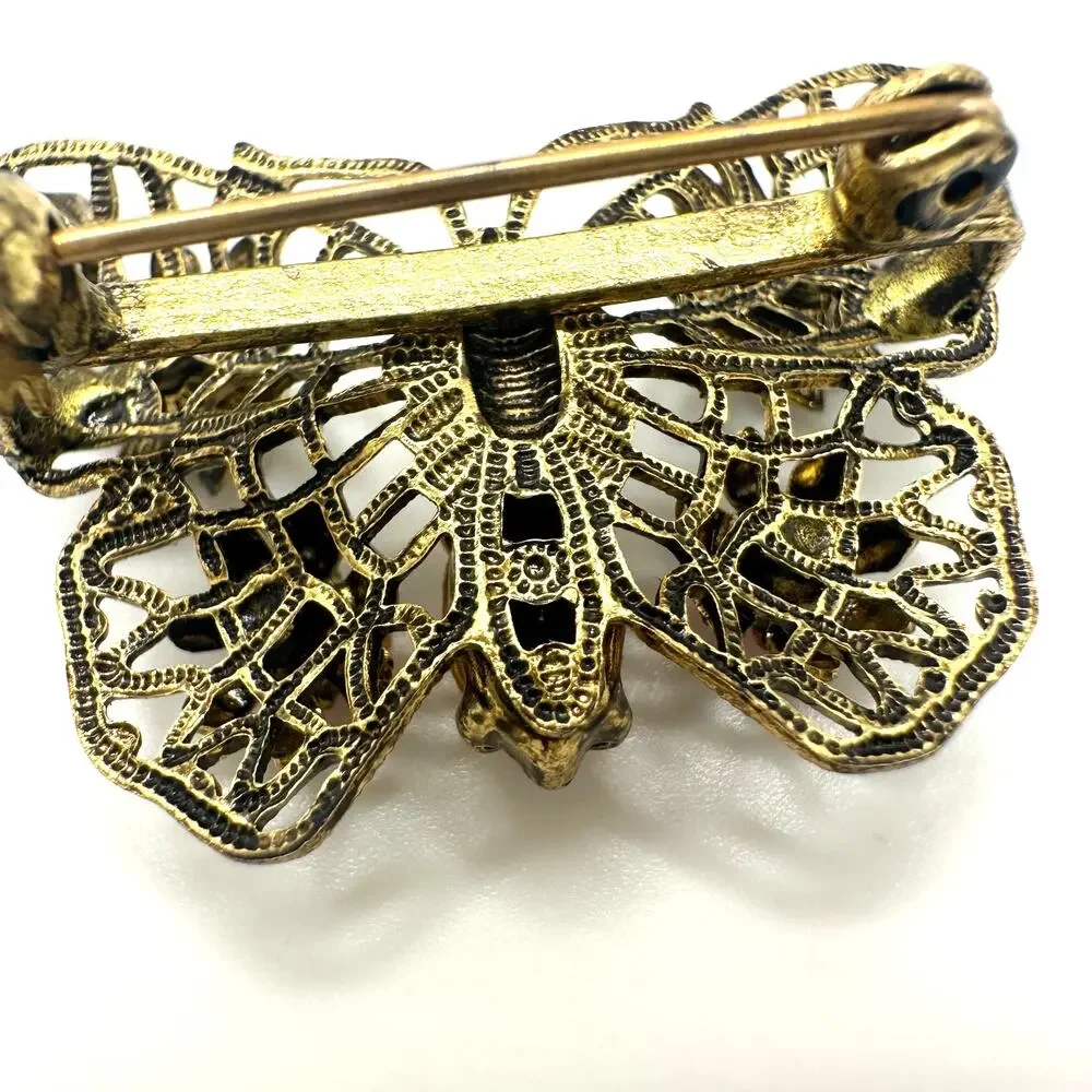 Vintage gold tone filigree multicolor prong set rhinestones butterfly brooch